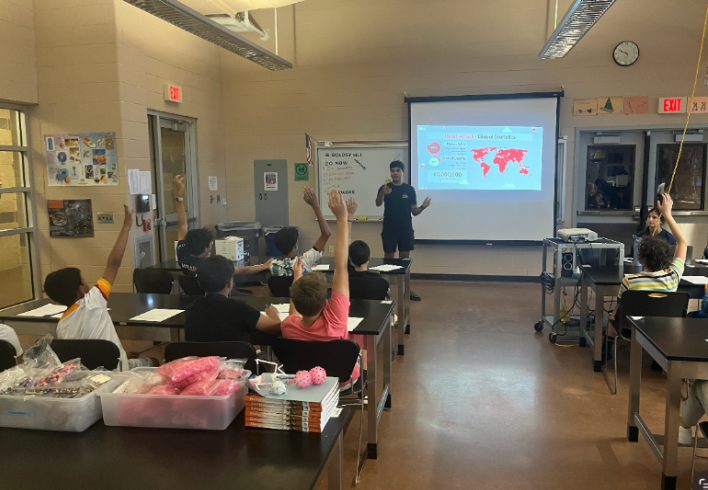 Students raise their hands to answer a question